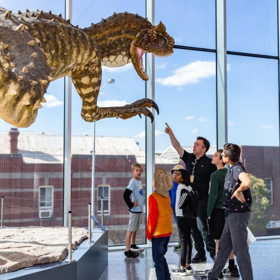 A tour group looking at one of the Museum's dinosaurs