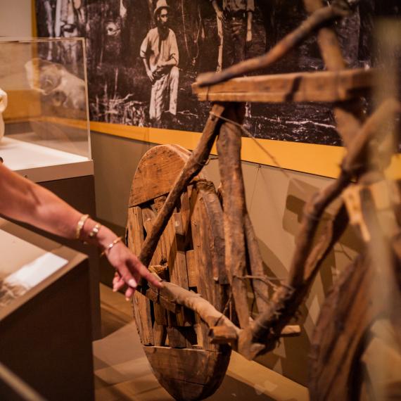 A wooden bicycle on display in a museum