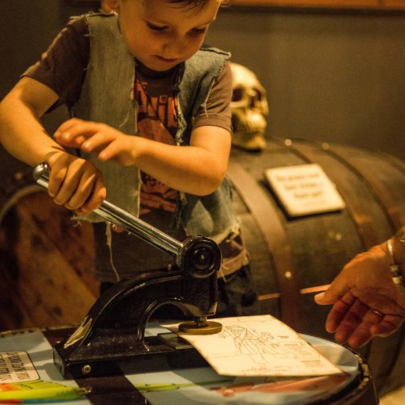 Young child plays with pirate equipment