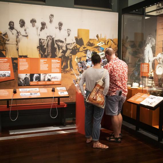 Image of visitors on a tour in the Reflections Gallery at WA Museum 