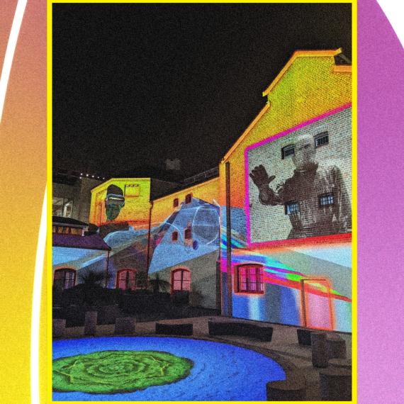 Light projections on the Old Gaol surround by a neon purple and yellow rectangle