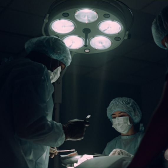 This image show medical staff around an operating table performing surgery