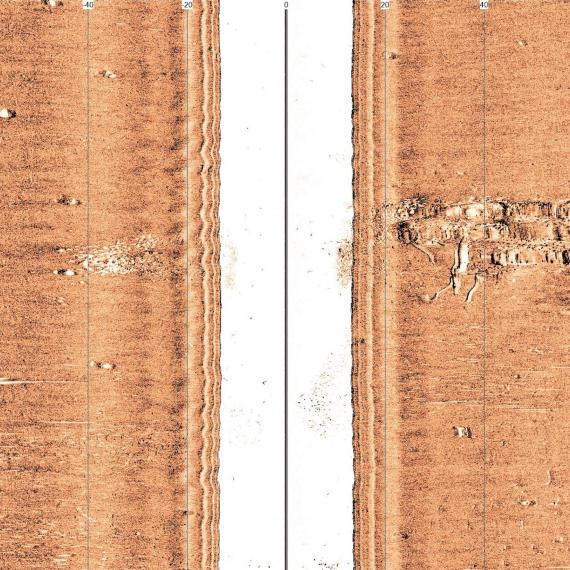 Two vertical lines, the one on the right shows the loose shape of a ship on its side.