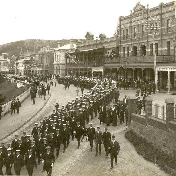Black and image of a marching band performing through the streets of Albany
