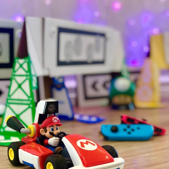 mage shows Mario from MArio Brothers sitting in a red car ready to race