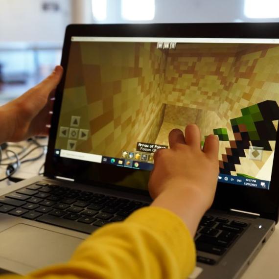 This image shows a laptop computer screen displaying a Minecraft scene which the participant is constructing 
