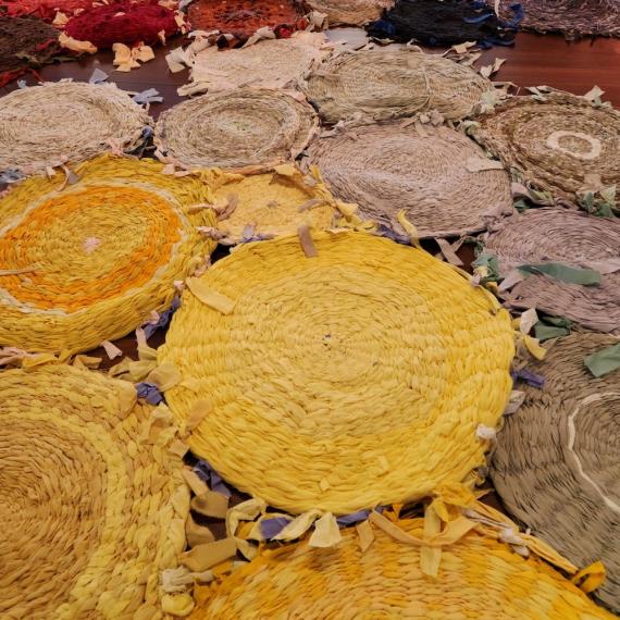 yellow and beige circular rugs spread out on a wooden floor creating a textural pattern 