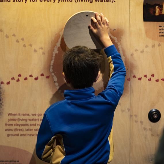 child reading a wall interactive 