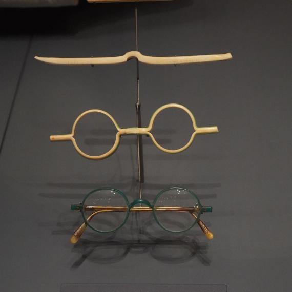 Image shows two pairs of  old, round spectacles made from toothbrush handles. 