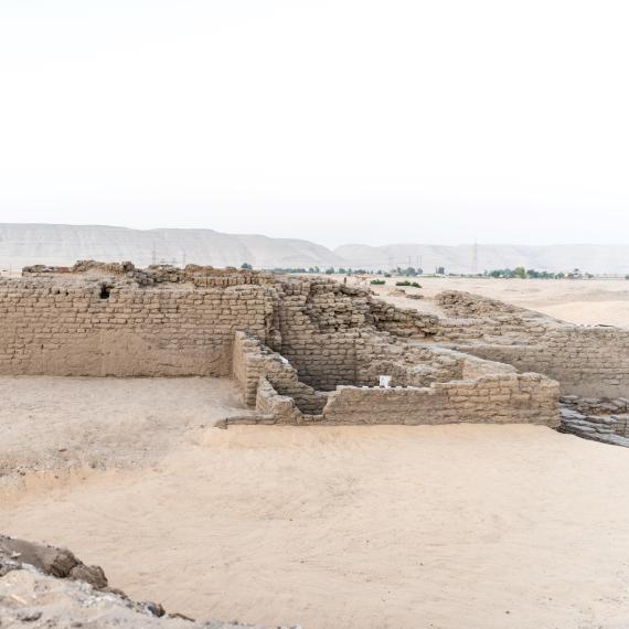 xcavation field in the Egyptian desert with a broken limestone wall