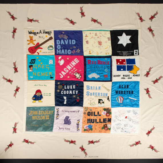 Patch of WA Aids Quilt with multiple names: Warren A Harris, David G Haig, Robert Frederick Castle, Greg Nemer, Jasmine, Reg Berle, Kerry Bushe-Jones, Luke Coomey, Brian Sorenson (Connies), Alan Webster, John Bradley Wilson III, In loving memory of Jerry King, Gill Mullen.