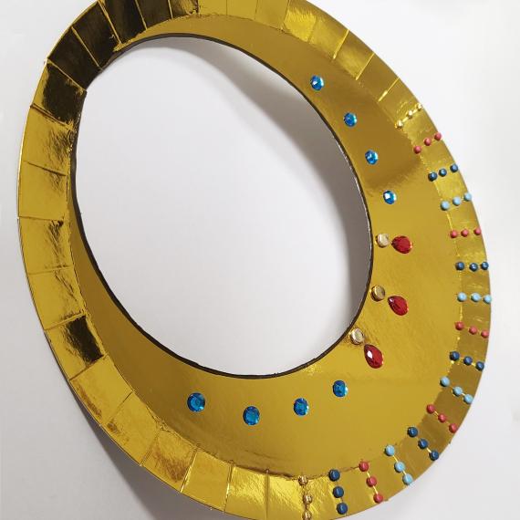 a golden necklace collar made from craft materials 