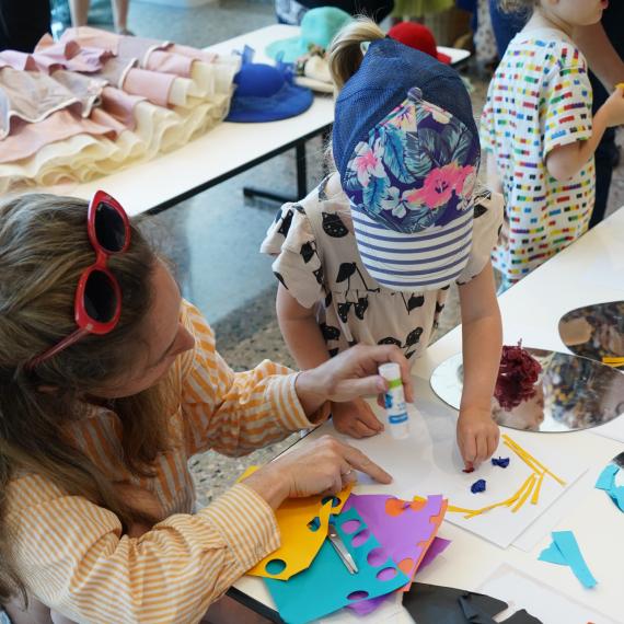 Adult and children creating some craft items.