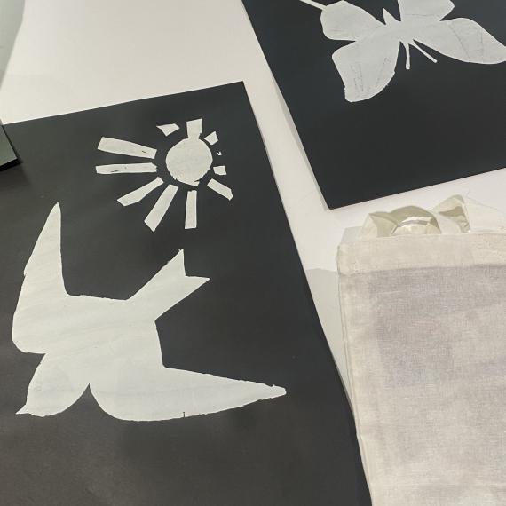 Tow screen printing stencils - a bird and a butterfly - cut out of black card
