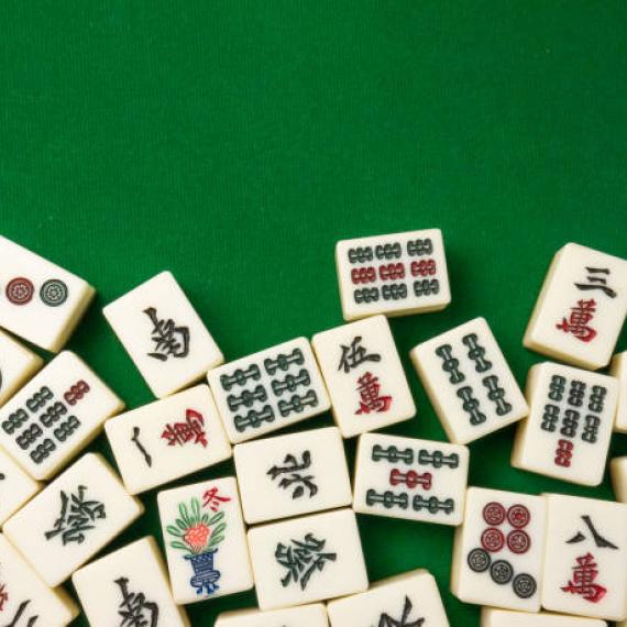 Assortment of Mahjong Tiles on green surface
