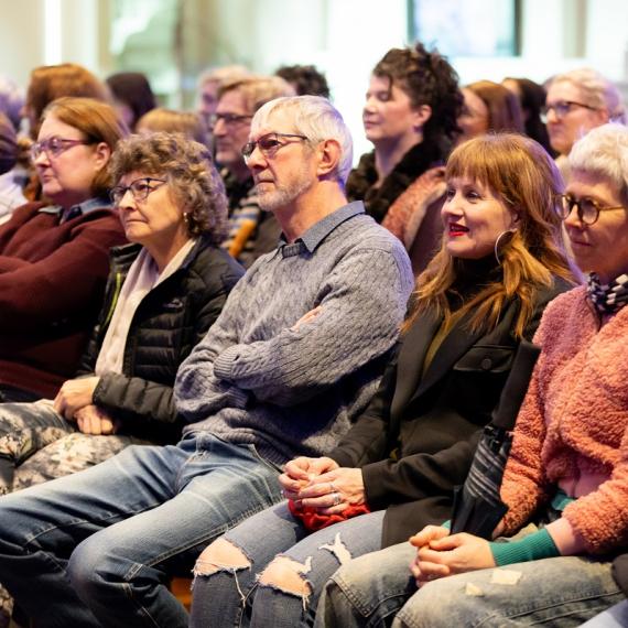a crowd of people seated and listening