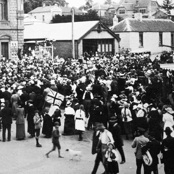 a historical image showing a large crowd gathered outdoors in commemoration 