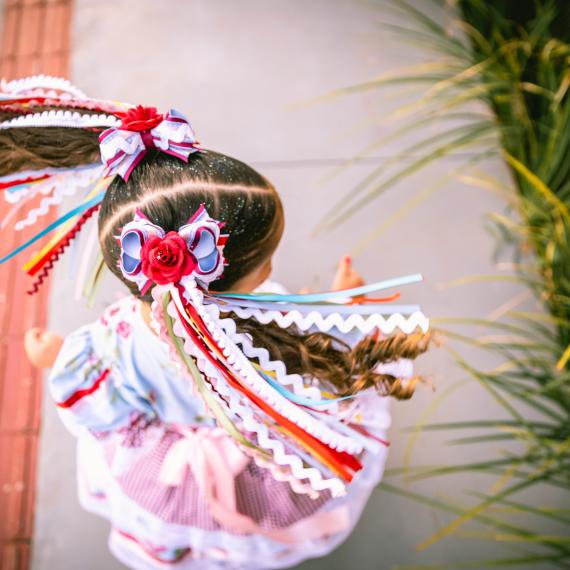 top view of a young cild dancing with Mexican inspired clothing decorations
