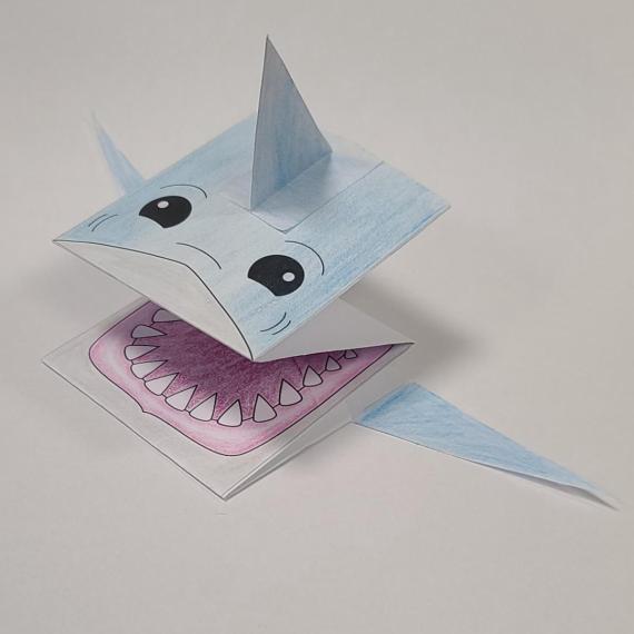 a paper shark folded and coloured in
