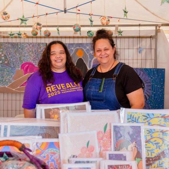 Two revealed artists with their work 