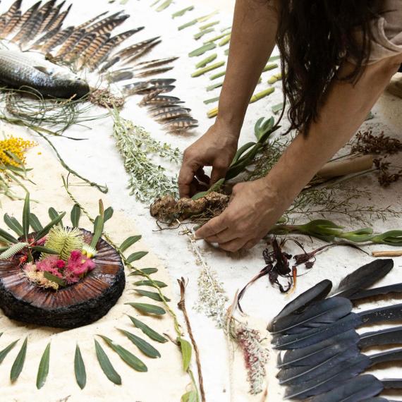 A detail image of artist Irma Woods creating a seasonal installation artwork during the Nyoongar season of Djeran as part of the 2024 artwork series Six Seasons Gathering: Walyalup, presented by Gathering Yorgas artist group as part of Fremantle Festival 2024.
