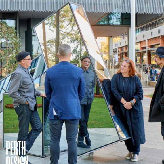 4 People standing around a Sculpture with the Perth Design Week Logo in the bottom Left corner