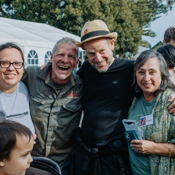 a group of people are all happy and smiling and laughing together outdoors 