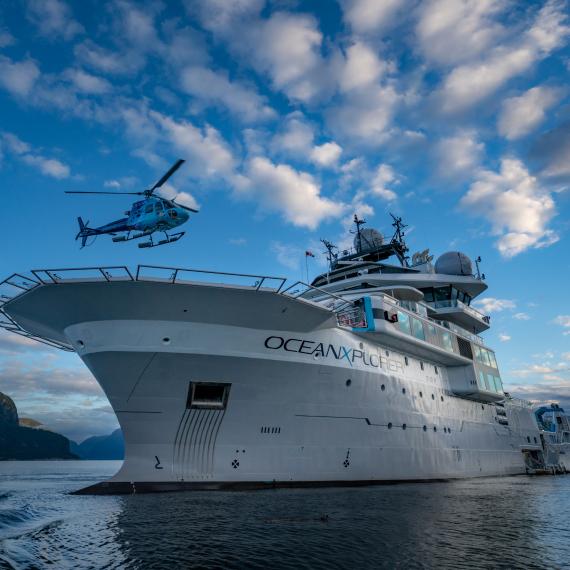 OceanXplorer research vessel on ocean with helicopter landing on deck