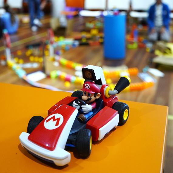 mario kart car with museum session happening behind it in the distance