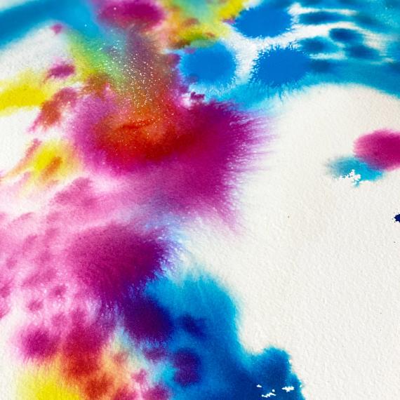 a colourful abstract artwork created with inks. there are circles of pinks, blues ad some yellow
