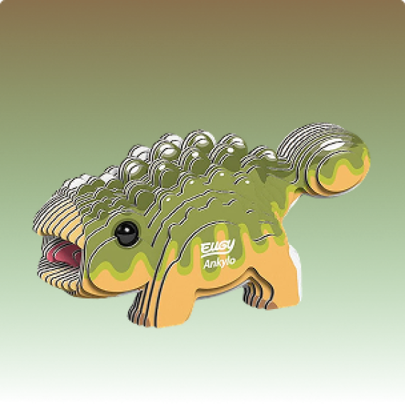 Cardboard ankylosaurus dinosaur model with a green and tan body, layered scales and large clubbed tail displayed against a green background.